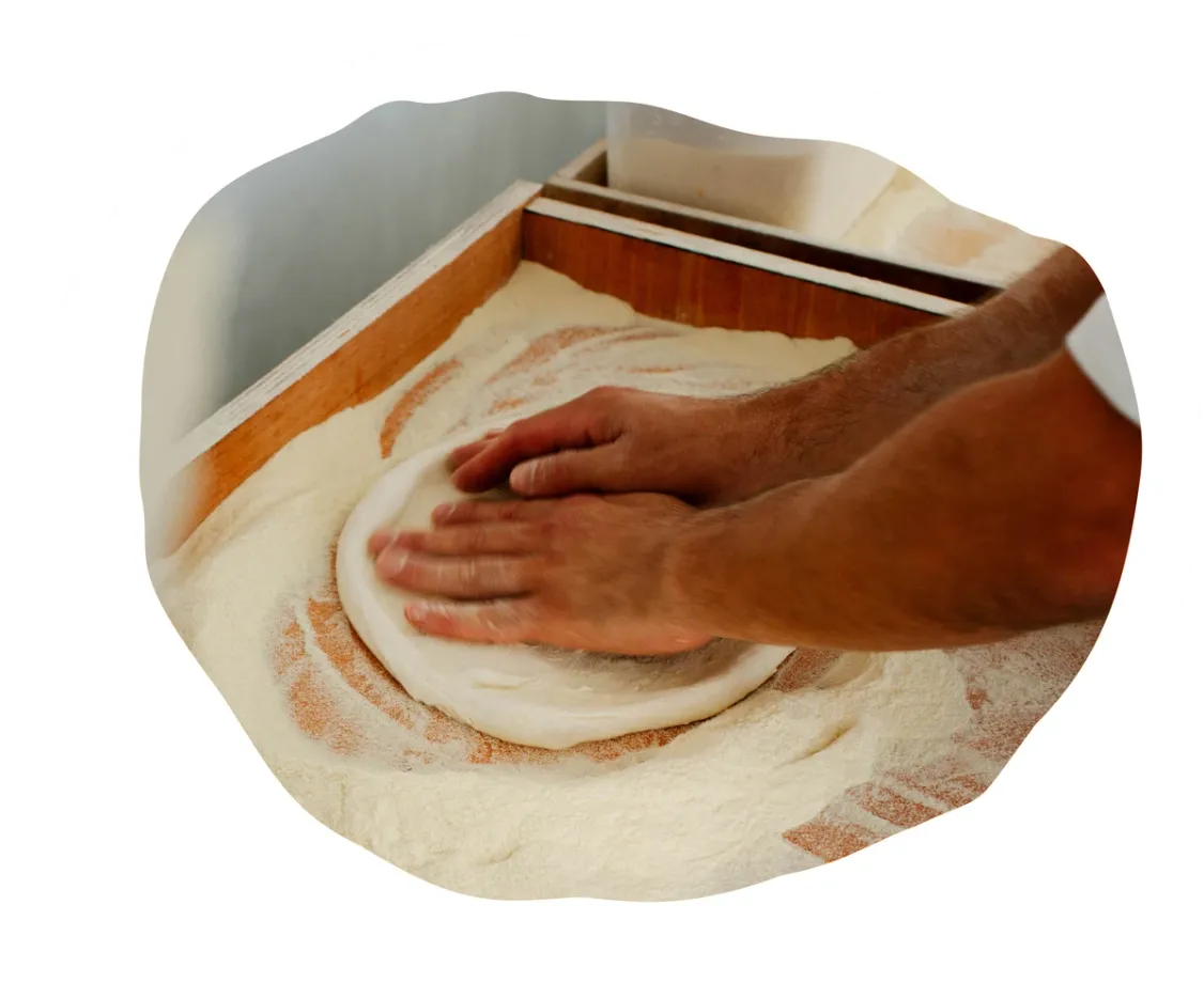 Stretching a pizza base by hand
